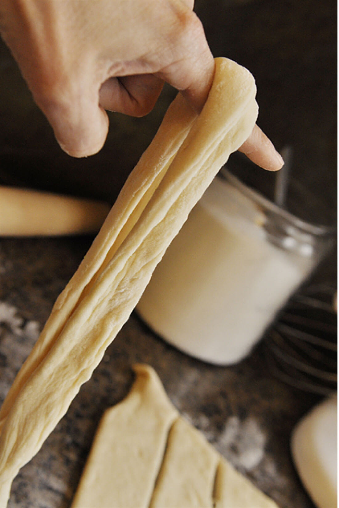 Cinnamon Sugar Breadsticks with Cream Cheese Frosting -step 5, drape finger over