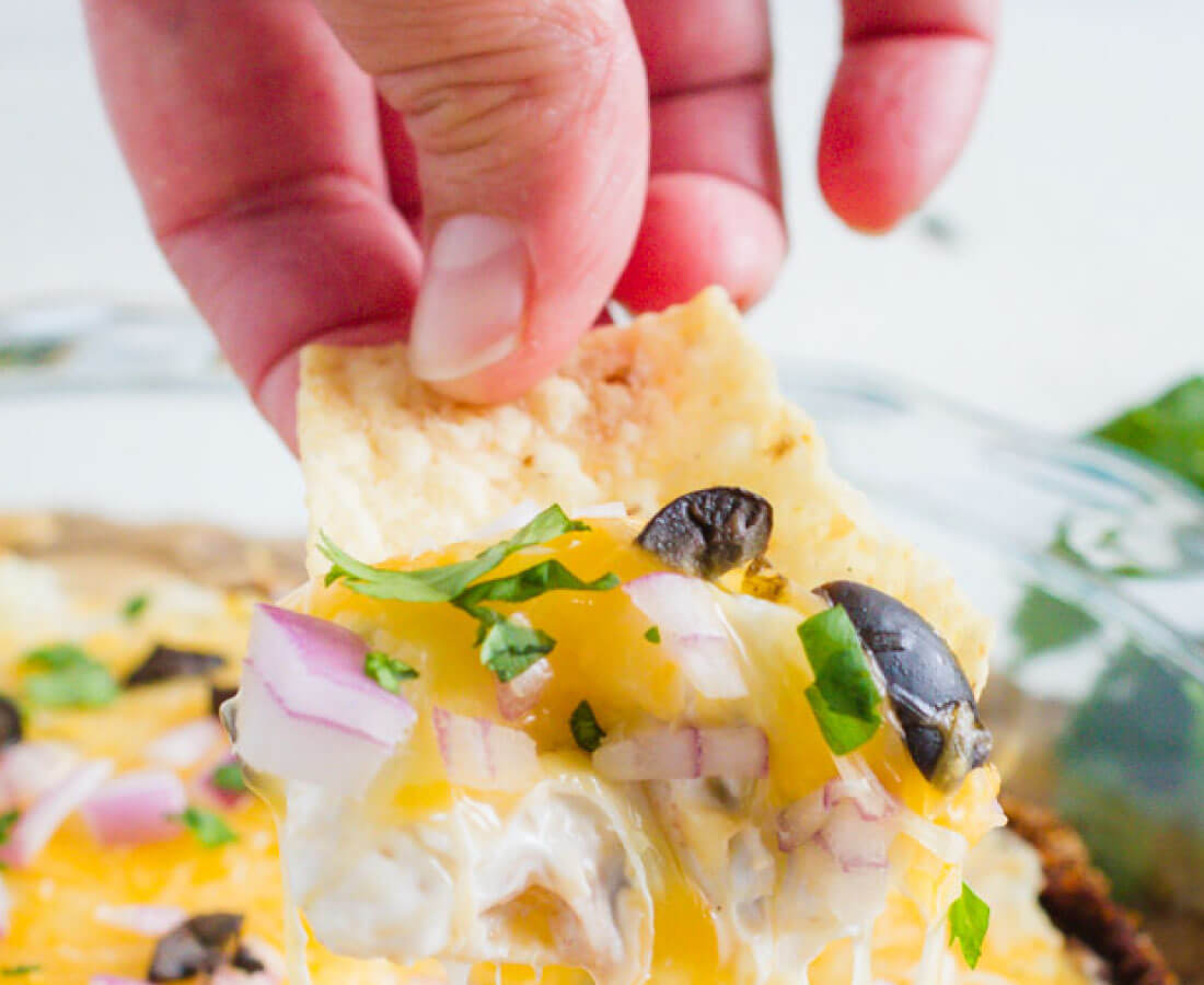 Layered Bean Dip - this bean dip recipe isn't your typical one. It has a little kick and a whole lot of flavor.