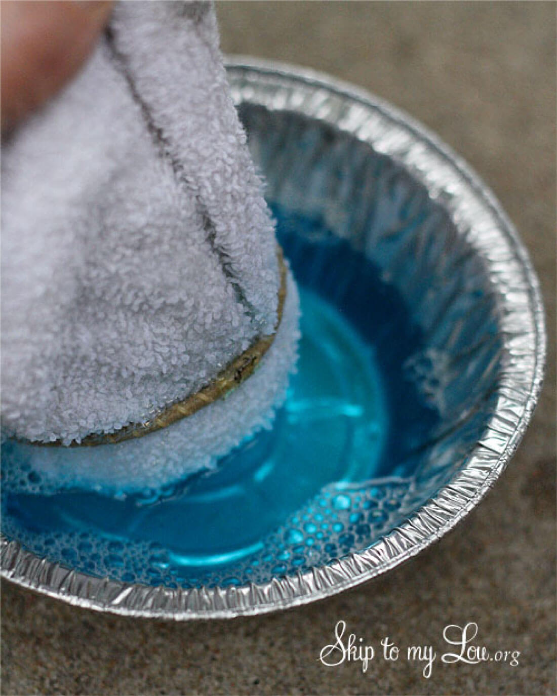 DIY Bubble Blower -dipping the washcloth in the bubbles.