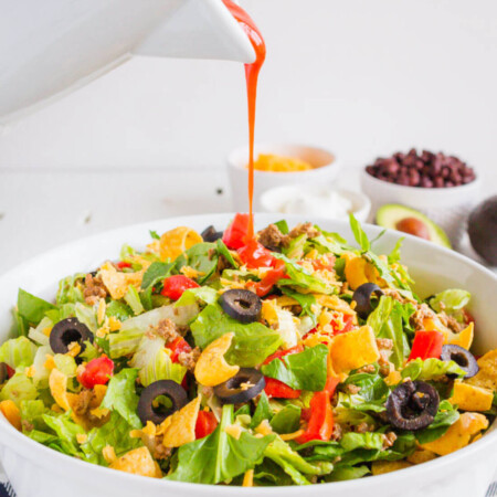 Mom's Taco Salad - make this easy dinner that your whole family will love. Pouring dressing