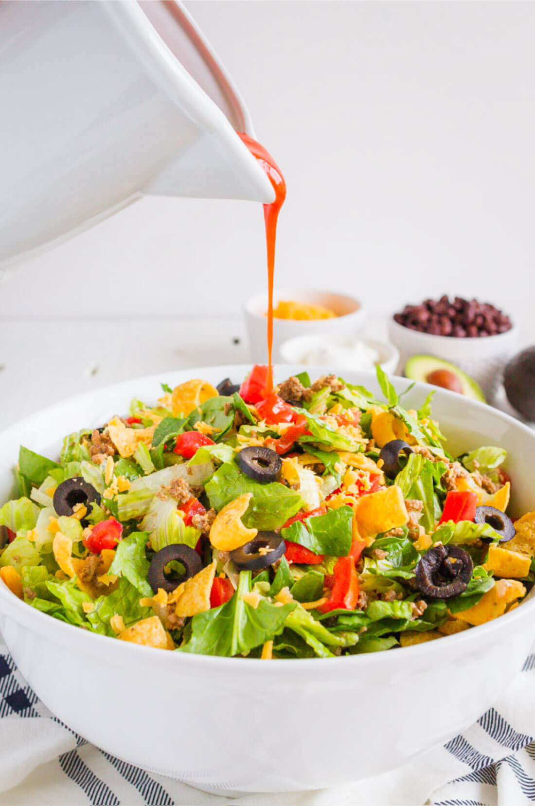 Mom's Taco Salad - make this easy dinner that your whole family will love. Pouring dressing