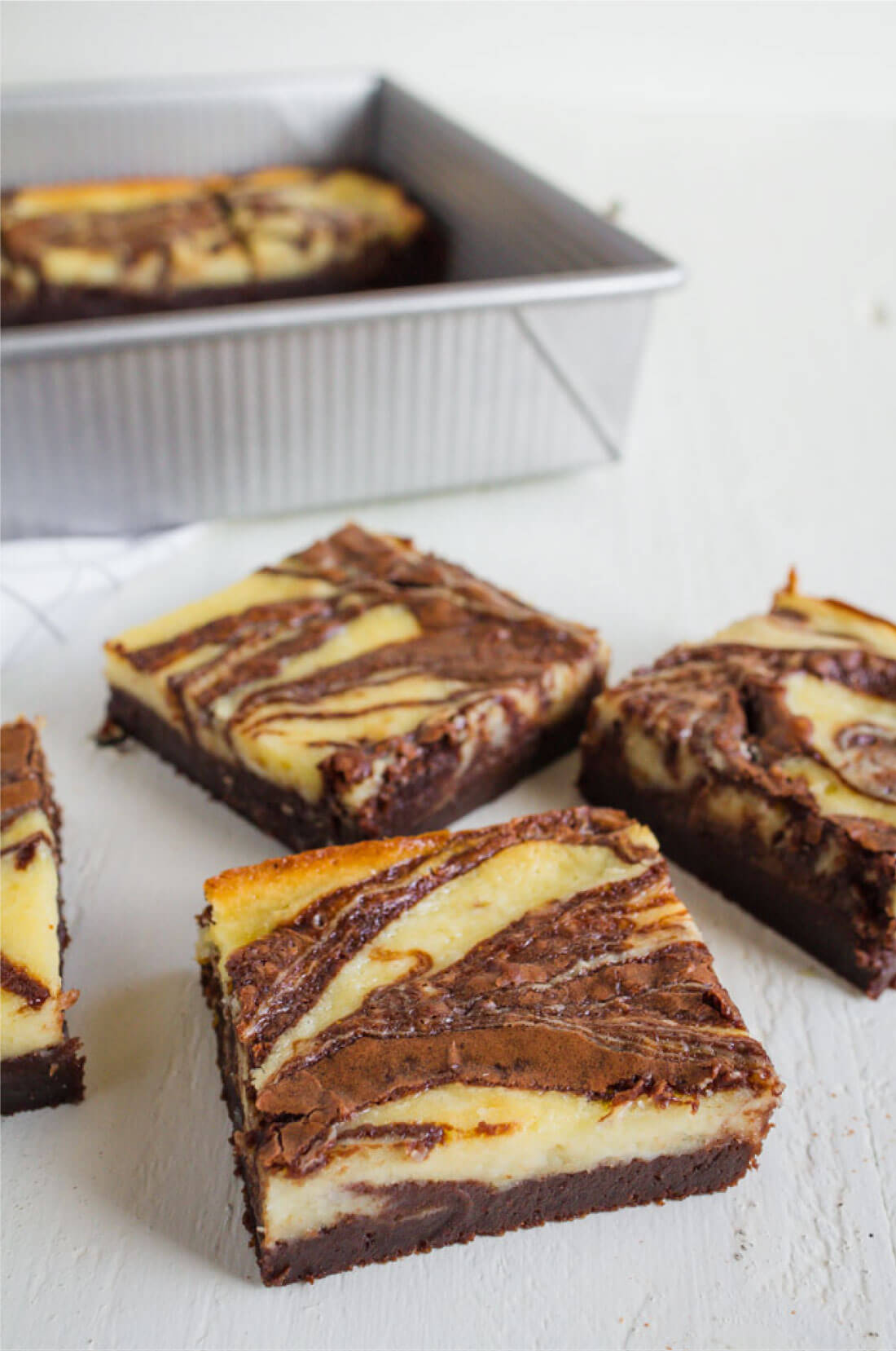 Cheesecake Brownies - they are delicious and simple and a fun take on regular brownies. Pan full of brownies and cut up.