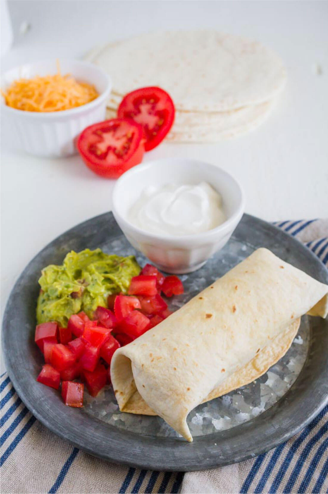 Make Ahead Beef Chimichanga Recipe - you can make a bunch to eat throughout the month. A full plate with all of the add ons.