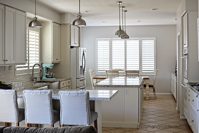 Kitchen with plantation shutters from www.thirtyhandmadedays.com