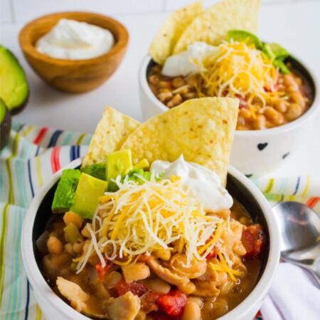 Slow Cooker White Bean Chicken Chili Recipe - a healthy recipe that your whole family will love. Shown with all of the toppings.