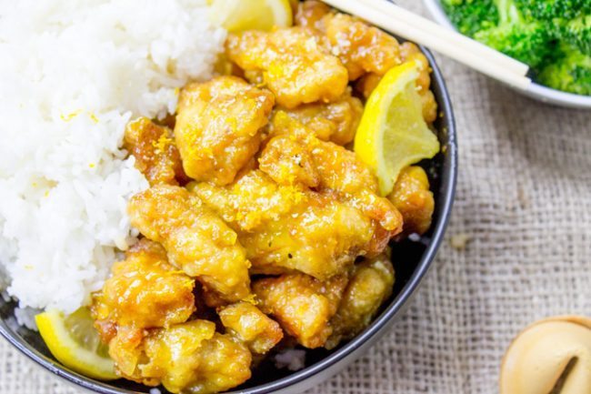 Classic Lemon Chicken with crispy battered chicken thighs in a sweet and tangy sauce. You can skip the delivery and the wait and make it at home!