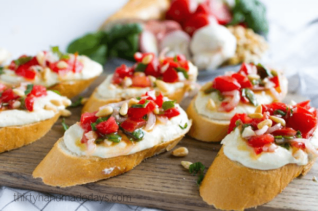 Tomato Crostini with Whipped Feta - this is the best appetizer ever. So delicious! from www.thirtyhandmadedays.com