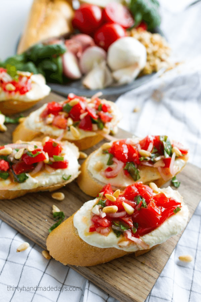 Tomato Crostini with Whipped Feta - this is the best appetizer ever. So delicious! via www.thirtyhandmadedays.com