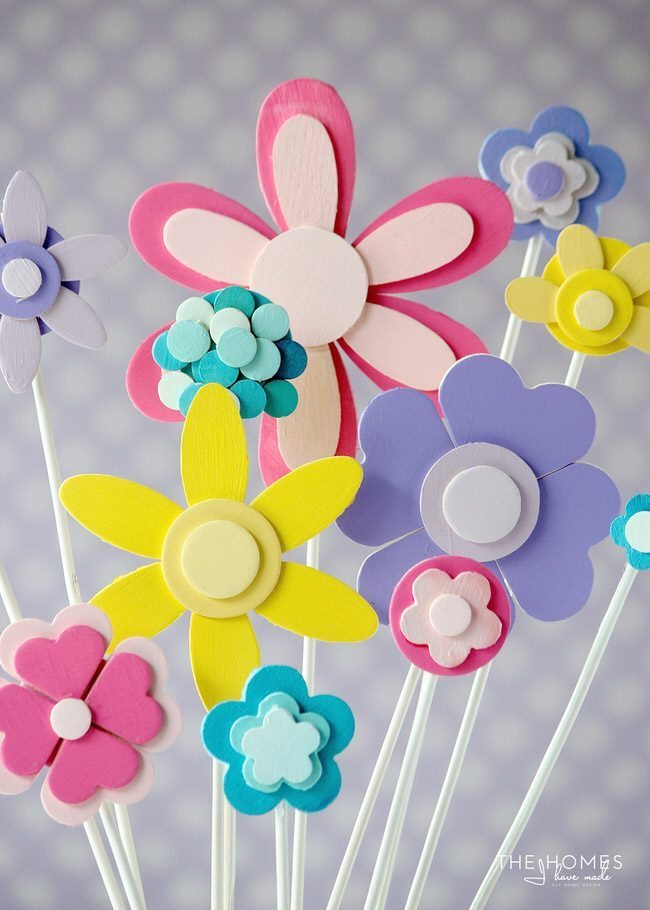 Glue and paint wooden shapes together to create a darling flower display...perfect for adorning a cake for any Springtime occasion!