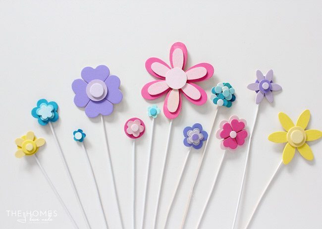 Glue and paint wooden shapes together to create a darling flower display...perfect for adorning a cake for any Springtime occasion!