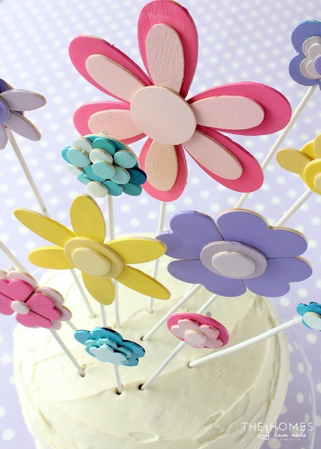 Glue and paint wooden shapes together to create a darling flower display...perfect for adorning a cake for any Springtime occasion!