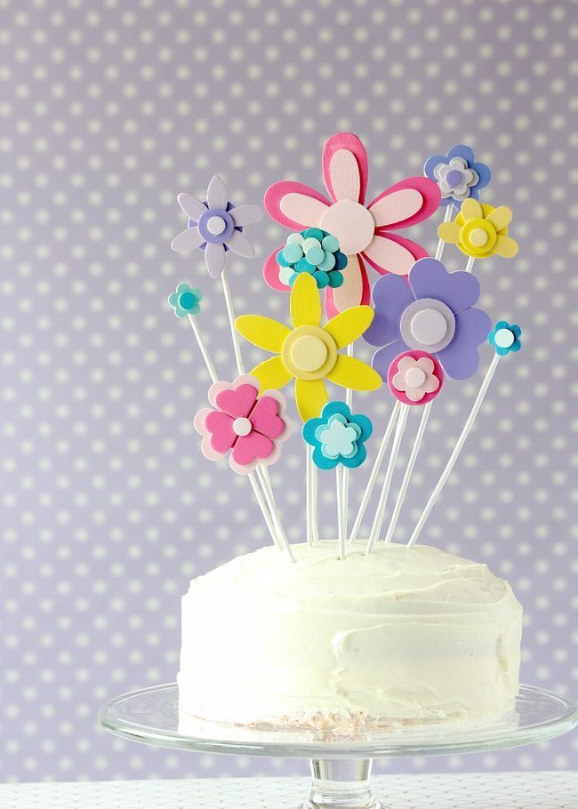 Glue and paint wooden shapes together to create a darling flower display...perfect for adorning a cake for any Springtime occasion!