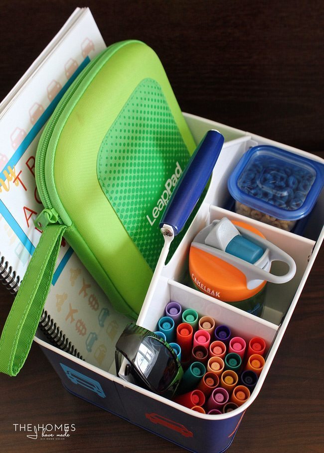 Fill a utensil caddie with all sorts of activities and treats to keep your kiddos entertained on your next car trip!