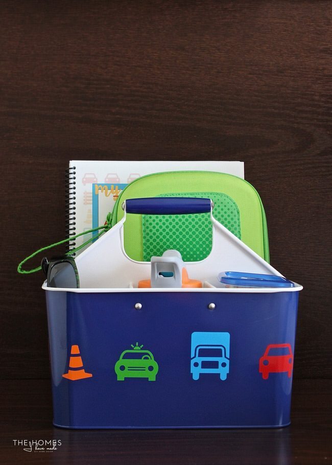 Keep the kids entertained on your next car trip with this easy, creative AND functional Car Caddie! Be sure to fill it up with all the treats and toys your kids love!