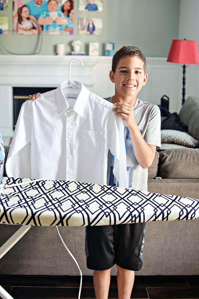 Teaching kids How to Iron - spraying Faultless Starch from thirtyhandmadedays.com