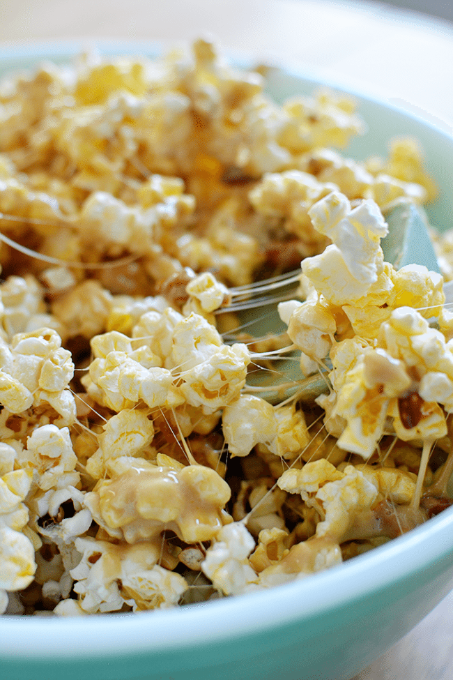 Salty and Sweet Caramel Popcorn Bars- how to make them, stirring the ingredients. A fun, delicious treat from www.thirtyhandmadedays.com