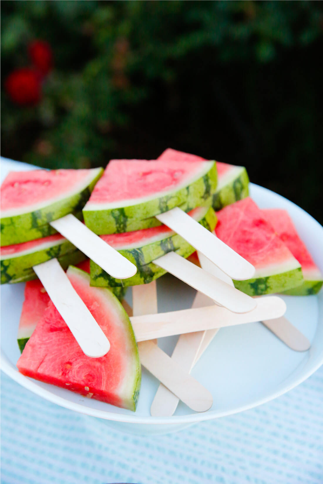 Watermelon on a stick for a summer party - so delicious! from www.thirtyhandmadedays.com