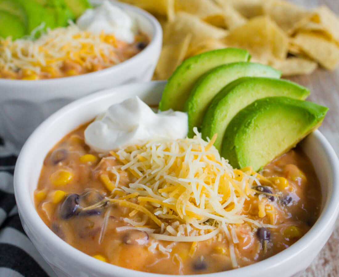 This delicious chicken enchilada soup is thick, cheesy, and ready to go thi...