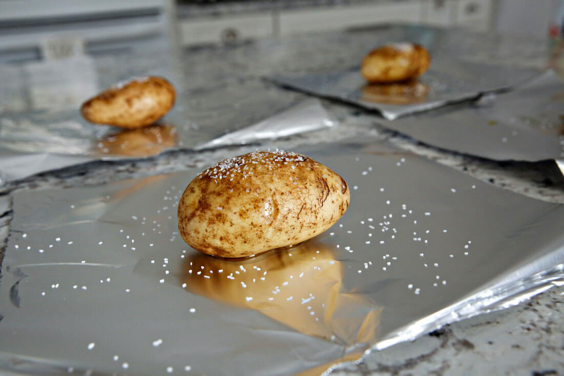 How to make Baked Potatoes in the Crockpot. Olive oil, kosher salt and tin foil - first step. from www.thirtyhandmadedays.com