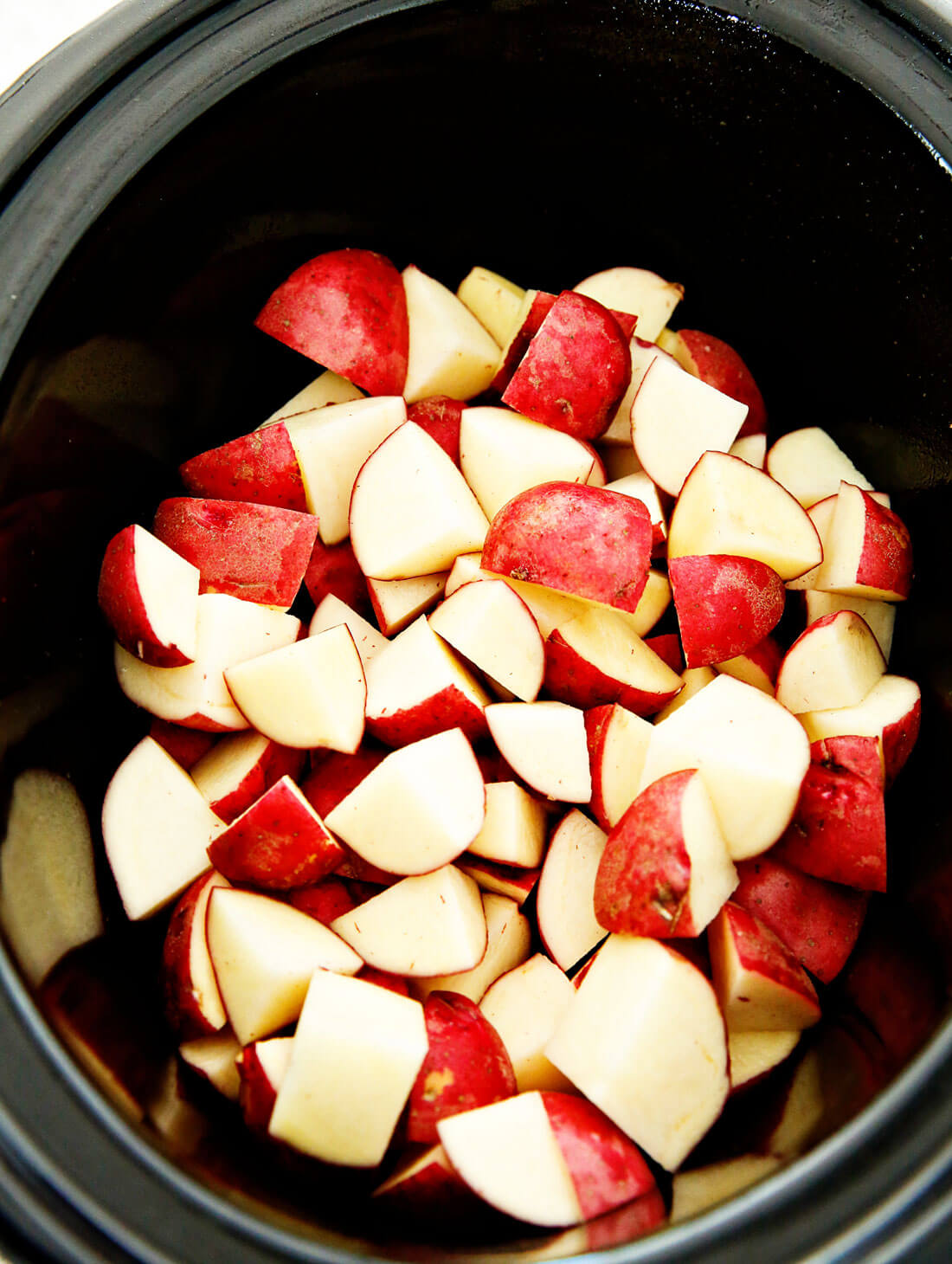 Crockpot Mashed Potatoes - make the most delicious mashed potato recipe you've ever had. Cut up potatoes. 