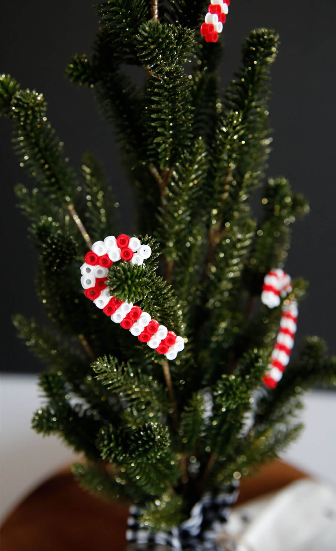 DIY Ornaments made with perler beads. Make these cute candy cane ornaments! These are super easy to make! from www.thirtyhandmadedays.com