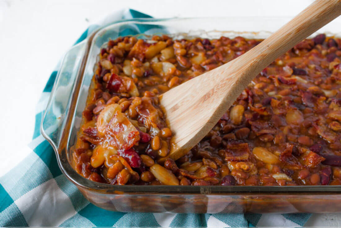 Delicious Baked Beans recipe - perfect for a summer barbecue! Pan with spoon